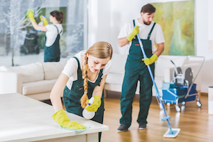 Cleaning service employees with professional equipment cleaning a private home after renovation